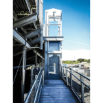 Vertical platform lift for stadium seating access at school