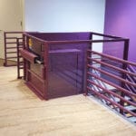 Symmetry Custom Vertical Platform Lift purple commercial setting installed by Area Access