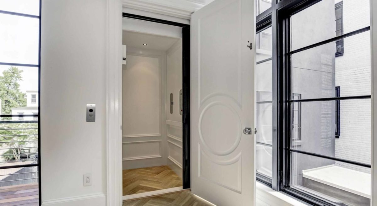 Symmetry Home Elevator in a Bright White finish and Stainless Steel fixtures