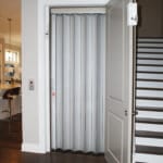 Symmetry Residential Elevator with Aluminum Accordion Door installed by American Elevator