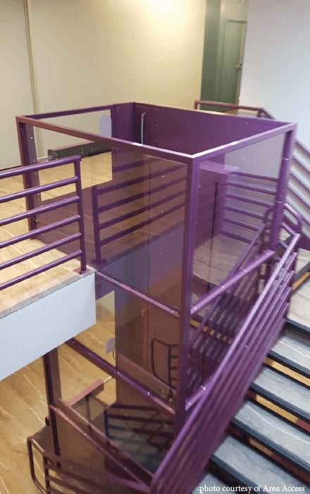 Symmetry Vertical Platform Lift in purple installed by Area Access