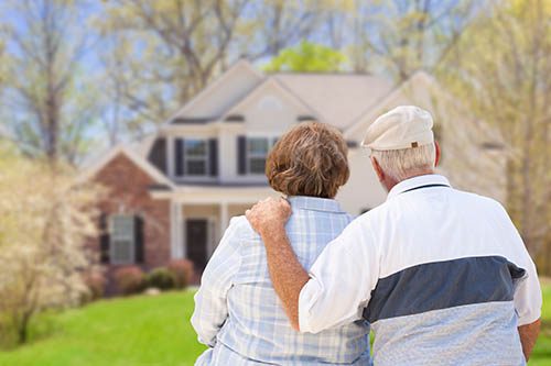 older couple looking at their home