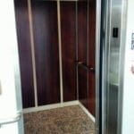 Symmetry LU/LA Elevator with applied panels flat Stainless Steel handrail